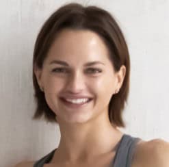 Smiling woman with short brown hair in a casual top.