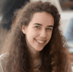 Smiling woman with curly hair outdoors, representing reliable auto transport services.