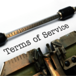Typewriter typing 'Terms of Service' on paper for legal document.