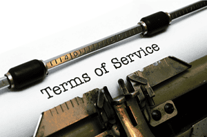 Typewriter typing 'Terms of Service' on paper for legal document.