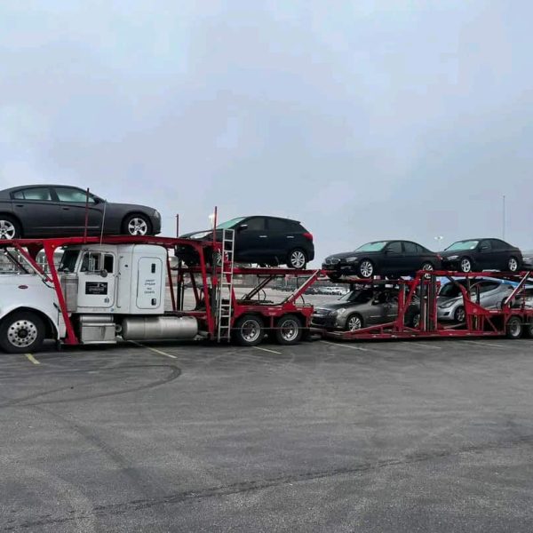 Automobile carrier truck transporting multiple cars for auto shipping.