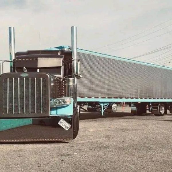 Large semi truck with trailer for vehicle shipping services.